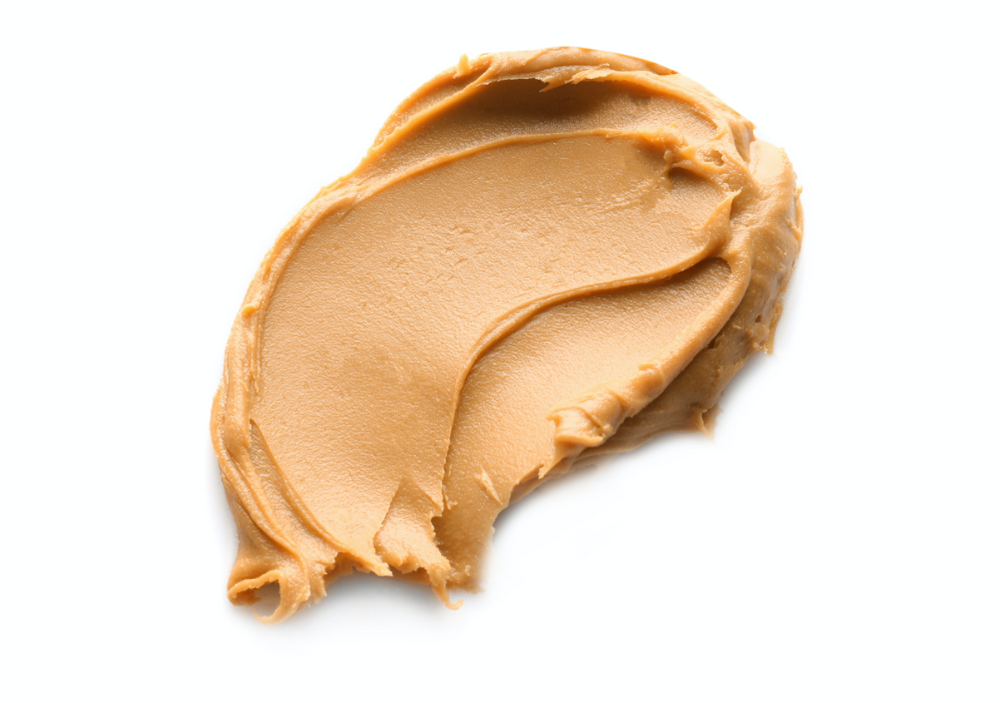 a smear of peanut butter on white background